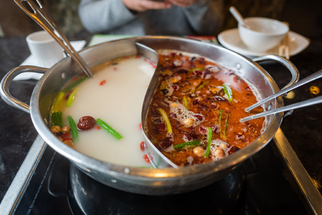 La olla 'yuanyang', dividida en dos, permite probar caldo picante y caldo no picante, China © Yiming Chen / Getty Images